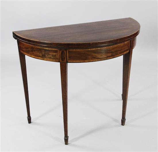 A George III mahogany and crossbanded demi lune folding card table, W.3ft